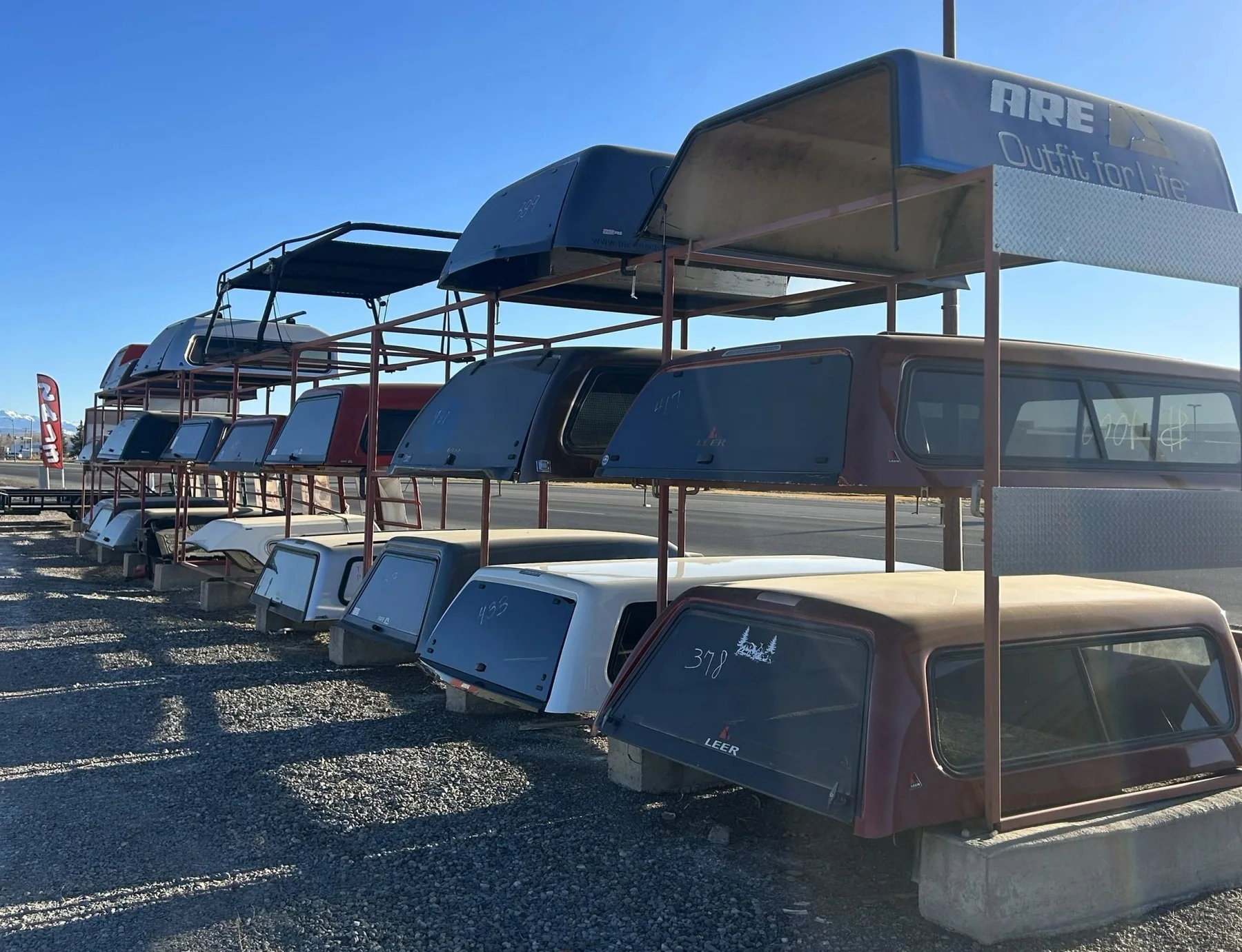 Used A.R.E. truck toppers on the lot at Big Country Trailers and Toppers in Montrose, CO